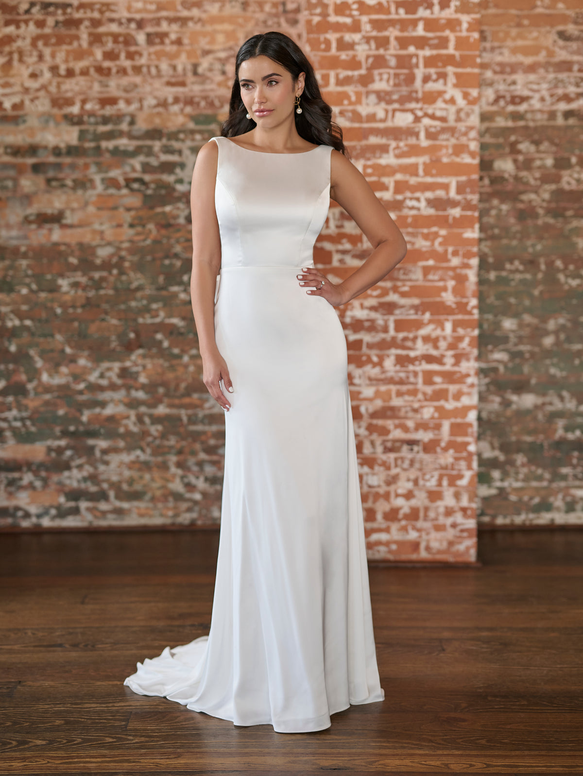 This stretch matte charmeuse gown has a chic, bateau neckline and slim skirt. The back features a plunging, low v and a simple bow.