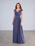 Woman wearing a long purple evening gown with beaded cap sleeves against a plain background / Slim A-line jersey gown features a combination of pleating and beaded lace. V-neck with cup sleeves. Side draping on front skirt.