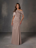 Woman wearing a long, off-shoulder dress against a gray background / Stretch charmeuse slim A-line with asymmetrical neckline and off-shoulder sleeve on one side.