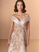 Woman wearing a beige off-shoulder dress with lace details against a beige background / A-line lace dress with mikado collar off-shoulder.
