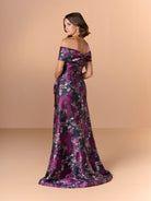 Woman wearing a floral off-shoulder gown on a beige background / Slim brocade style with collar/straps twist, pleating on front bodice.