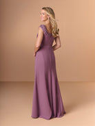 Woman wearing a purple gown with floral details on a beige background / Cap sleeve fitted gown with pleated detail on the bodice and 3D embellishment.