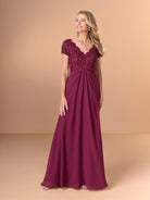 A woman modeling a floor-length burgundy formal gown with a beaded lace bodice, short cap sleeves, and a flowing skirt against a solid tan studio background. / A-line style with lace bodice and chiffon skirt. V-neck edge and short sleeves hemline edge finished with scallops. Draping on front and back skirt in fan shape.