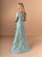 A woman modeling an off-the-shoulder floor-length gown in a light aqua blue and white jacquard pattern, photographed against a solid warm beige studio backdrop. / Slim jacquard style with collar/straps twist, pleating on front bodice.