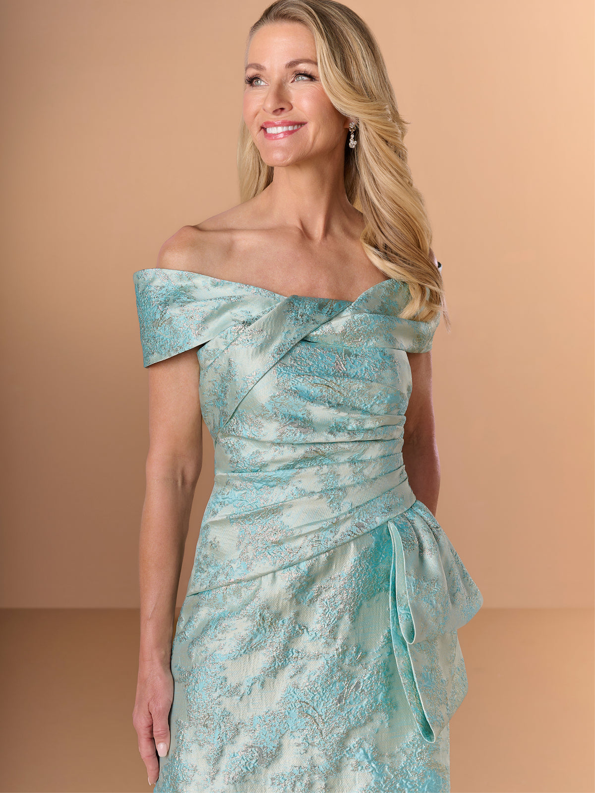 Woman wearing a light blue off-shoulder dress against a beige background / Slim jacquard style with collar/straps twist, pleating on front bodice.