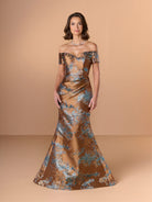 Woman wearing a bronze off-shoulder gown with floral patterns on a beige background / Slim brocade style with sweet off-shoulder neckline, short sleeves, draping on stomach area.