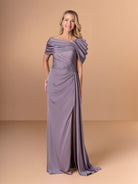 A woman modeling a floor-length off-the-shoulder gown in a dusty lavender-purple shade, standing against a solid warm beige studio backdrop. / Slim style in stretch charmeuse with asymmetrical neckline draped with detachable collar. Side draping on bodice finished with beaded motif on waist area.