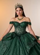A woman wearing an ornate off-the-shoulder emerald green ball gown with sparkling beadwork and a full layered skirt, styled with a matching green crown, necklace, and earrings against a warm beige studio background. / Luxurious off-shoulder ball gown featuring glittering embellishments, layered draped skirt details, and a dramatic cathedral-length train for a breathtaking princess-inspired look.
