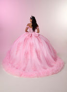 A woman viewed from behind wearing an elaborate off-the-shoulder pink ball gown with a very full tulle skirt, large bow at the back, and floral lace detailing, posed against a soft pink studio backdrop. / Glamorous off-shoulder ball gown with sparkling embellishments, a fitted corset bodice, a voluminous skirt, and a dramatic ruffled hem for a grand princess-inspired look.