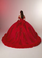 A model viewed from behind wearing a voluminous red ball gown with intricate beadwork and a large bow at the back, set against a neutral studio backdrop with a pinkish gradient on the left. / Glamorous off-shoulder ball gown with sparkling embellishments, a fitted corset bodice, a voluminous skirt, and a dramatic ruffled hem for a grand princess-inspired look.