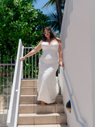 Slim style mock two piece with solid bodice in double face satin and lace skirt. Sweetheart sculpted neckline and lace up back closure.
