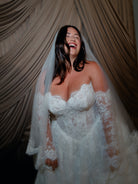 Ball gown in corded lace with sweetheart neckline and lace up back closure. Long detachable lace sleeves.