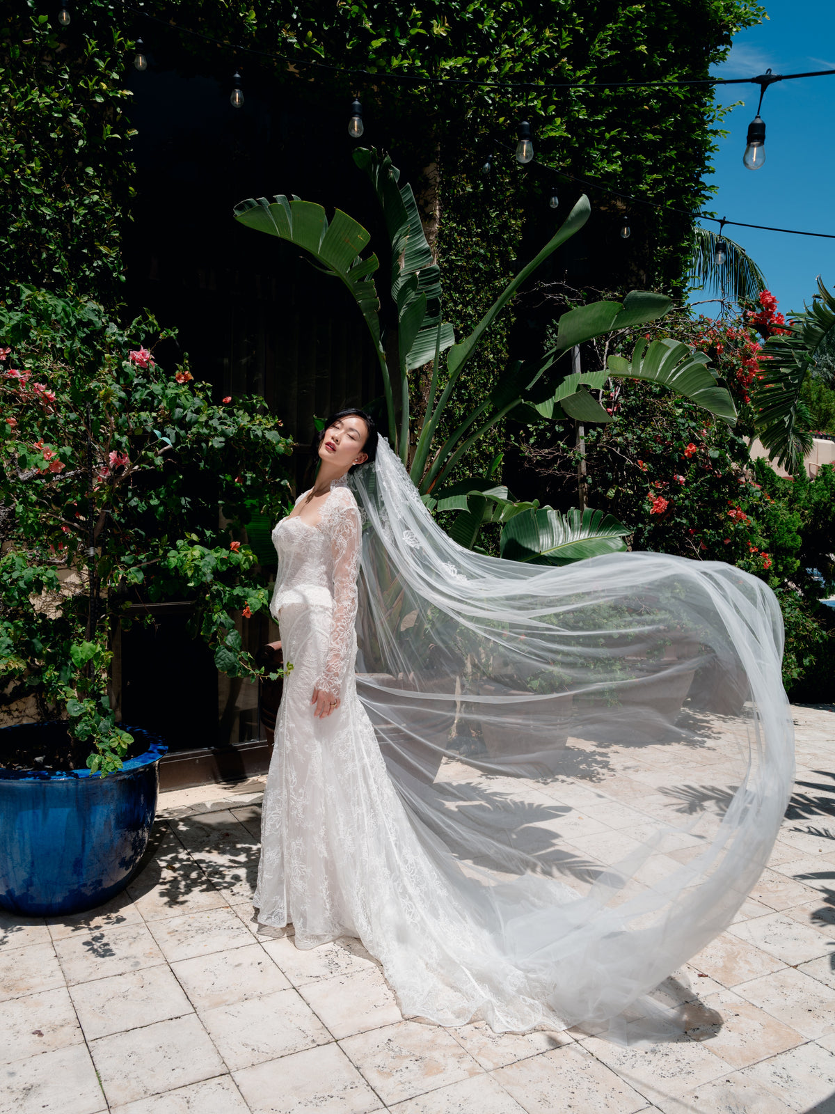 Slim lace gown with semi-sheer bodice with sweetheart neckline and bustier cut. Small peplums on sides hips. Invisible zipper back closure. Matching lace bolero with long sleeves. Long tulle veil with lace motifs scattered on top area.