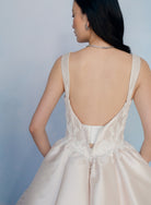 Dramatic, sculpted Mikado gown with lace placement.