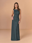 Woman wearing a dark green evening gown against a beige background / All over beaded gown with body shirring and back cowl neckline.