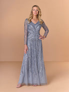 Woman wearing a long, elegant dress with intricate patterns on a beige background / All over beaded gown with v neckline, long sleeves and A-line skirt.