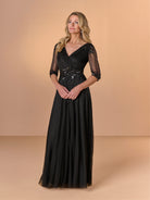 Woman wearing a black evening gown with sheer sleeves against a beige background / All over beaded gown with surplice bodice, elbow length sleeve and full A-line skirt.