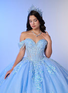 A woman wearing a voluminous light blue ball gown with intricate beadwork, off-the-shoulder straps, and a matching blue tiara and necklace, posed against a soft blue studio background. / Luxurious off-the-shoulder ball gown with intricate detailing and a statement bow at the back.