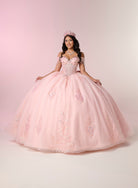 A young woman wearing a voluminous light pink ball gown with floral embroidery and a matching pink tiara, posed against a soft pink studio backdrop. / Luxurious off-the-shoulder ball gown with intricate detailing and a statement bow at the back.